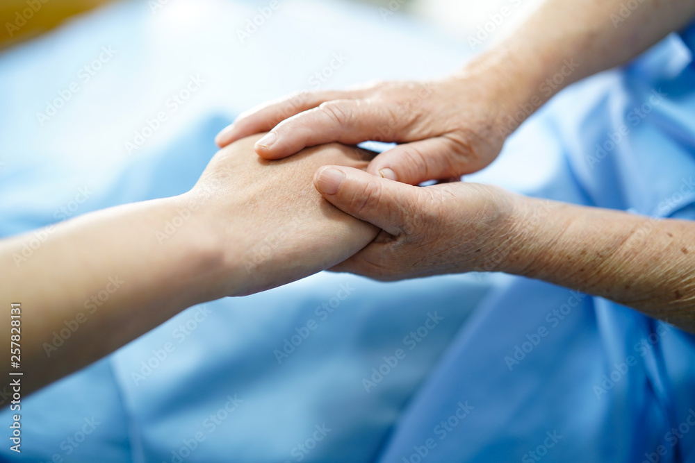 Holding hands Asian senior or elderly old lady woman patient with love, care, encourage and empathy at nursing hospital ward : healthy strong medical concept 