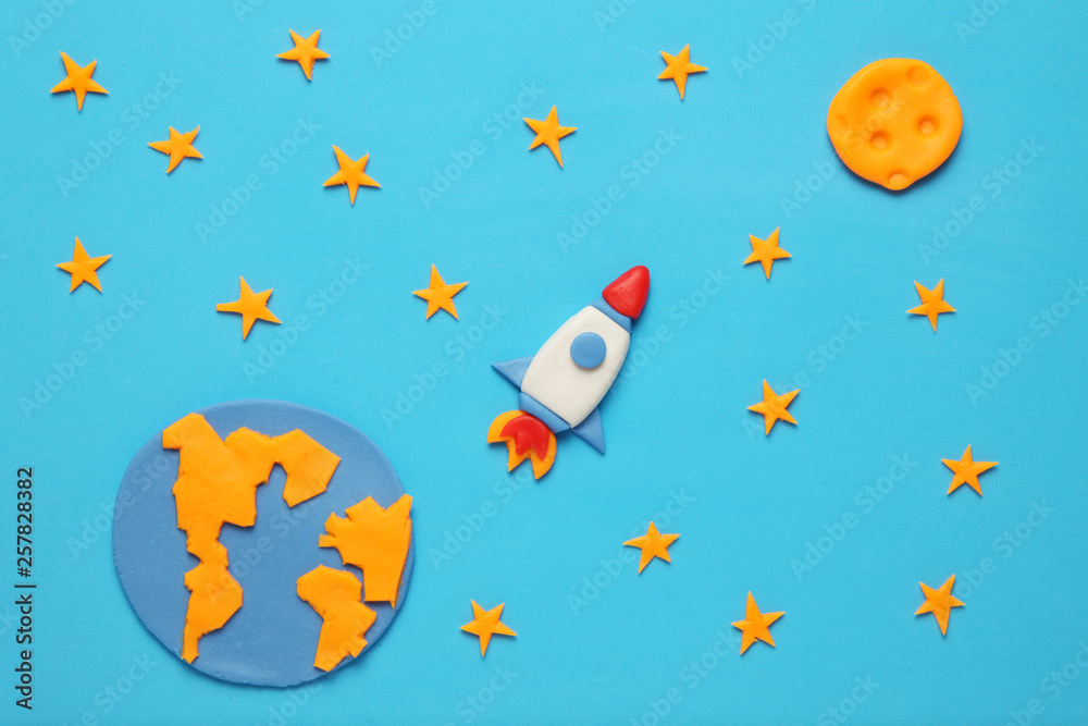 Creative craft plasticine rocket in open space, astronaut dreams. Stars, planet earth and moon. Cartoon art. Creative craft plasticine rocket in open space, astronaut dreams. Stars, planet earth and moon. Cartoon art.