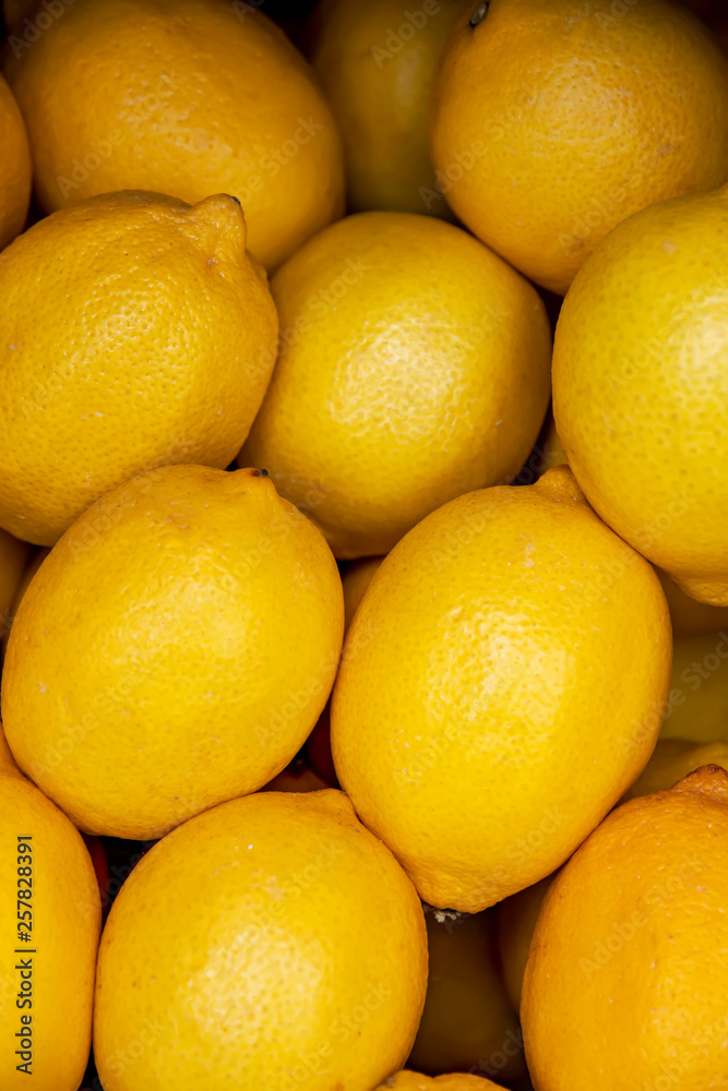 Heap of yellow ripe lemons close-up top view