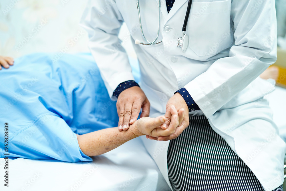 Doctor catch the pulse with Asian senior or elderly old lady woman patient in nursing hospital ward : healthy strong medical concept. Doctor catch the pulse with Asian senior or elderly old lady woman patient in nursing hospital ward : healthy strong medical concept.