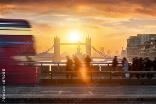 Silhouettes of traffic and people going to work during the early morning rush hour in London, UK, with the Tower Bridge in the background