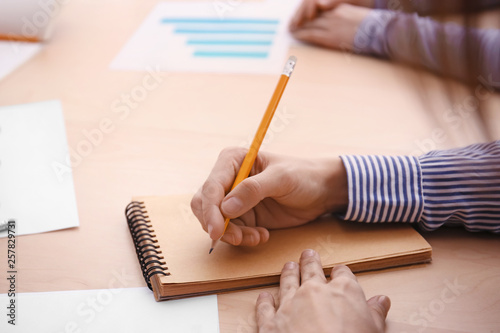 Fotografija Woman sitting at table during business meeting