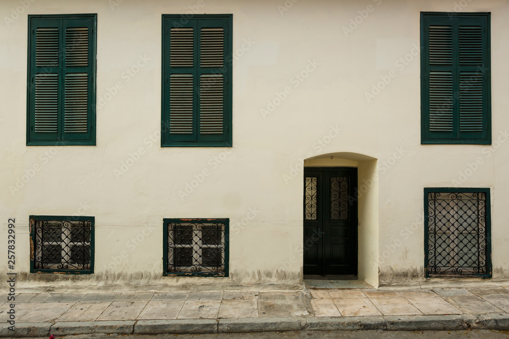Facade of a neoclassical building in the old town of Athens, Greece. Facade of a neoclassical building in the old town of Athens, Greece.