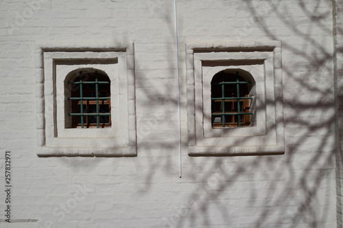 two old windows on the background of a white brick wall. Moscow, Russia