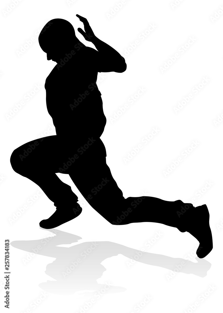 A male street dance hip hop dancer in silhouette A male street dance hip hop dancer in silhouette