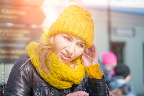 beautiful stylish girl listening to music in the city street © bisonov