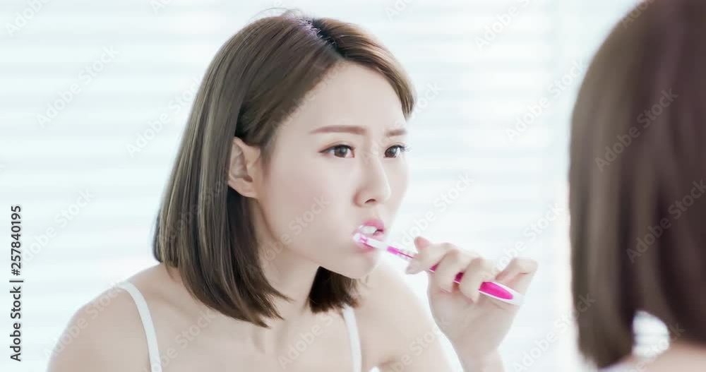 Asian woman brush her teeth