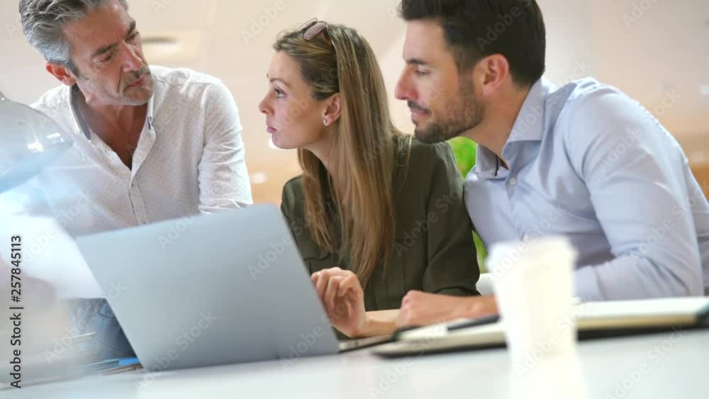 Diverse startup company working together in modern office space Diverse startup company working together in modern office space