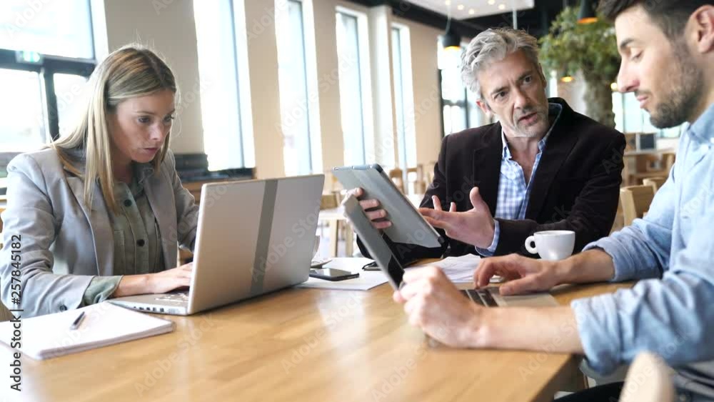 Diverse sales team prepping meeting in modern office space Diverse sales team prepping meeting in modern office space