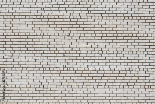 Old brickwork. Brick wall. White silicate brick. Crumbling brick from time to time.