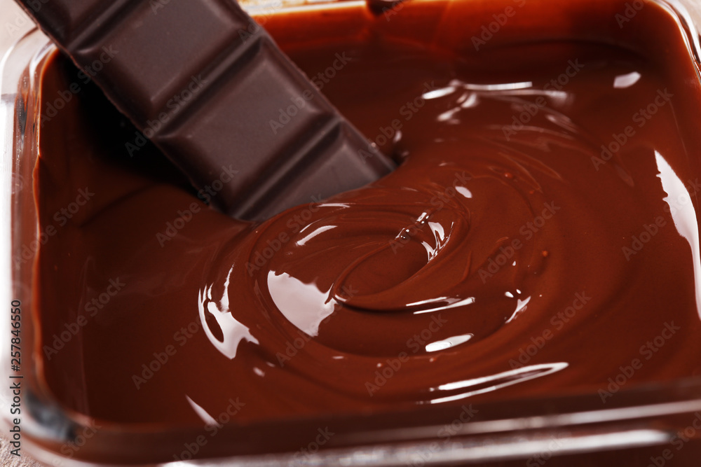 Melting chocolate, melted delicious chocolate for handmade praline icing confectionery Melting chocolate, melted delicious chocolate for handmade praline icing confectionery