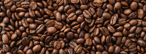Roasted coffee beans background. Top view. Space for text.