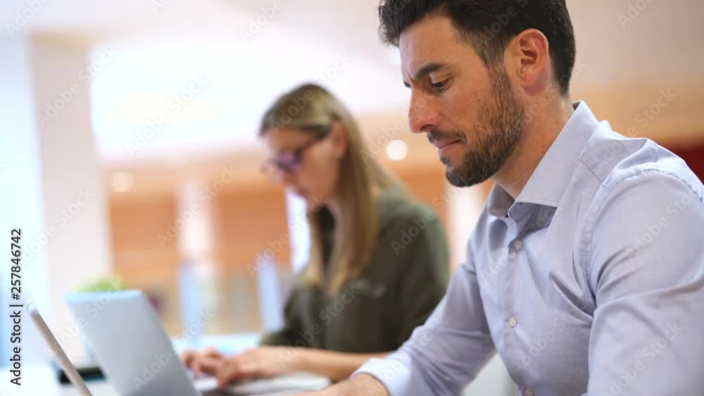 Colleagues working in contemporary office space Colleagues working in contemporary office space