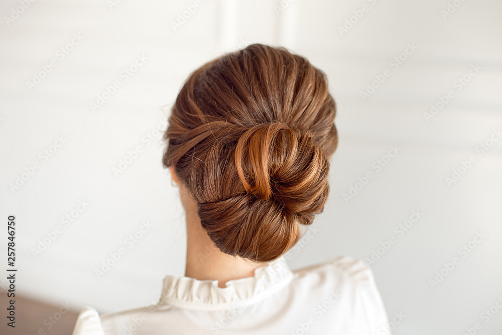 Rear view of female hairstyle medium bun with dark hair. Rear view of female hairstyle medium bun with dark hair.