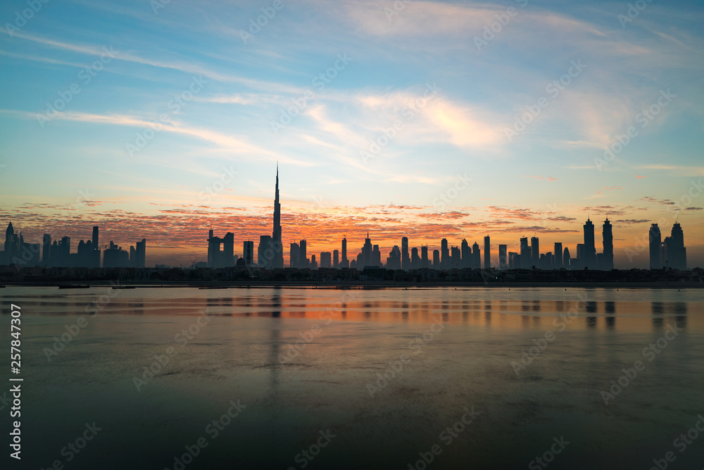 Morning or sunrise in Dubai. Dawn over Burj Khalifa. Beautiful colored cloudy sky over downtown Dubai. Glow over buildings