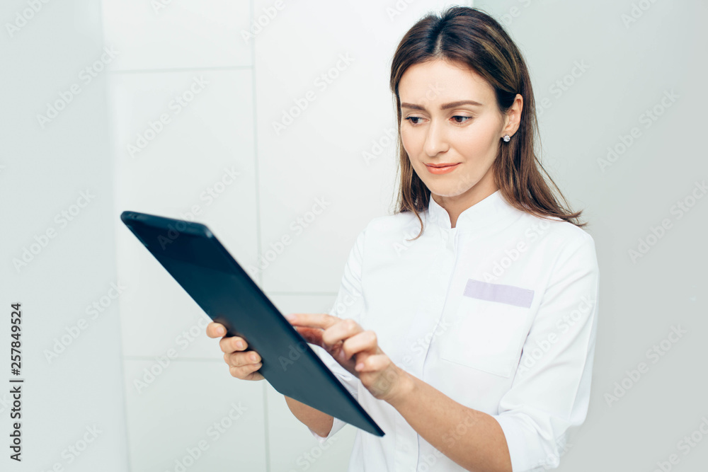 Shot of a female doctor using a digital tablet in in clinic Shot of a female doctor using a digital tablet in in clinic