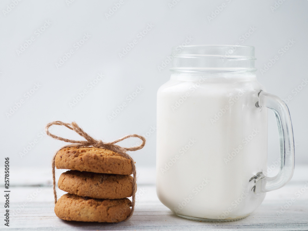 Milk and cookies on a wooden white table Milk and cookies on a wooden white table