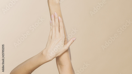 Women s hands on a beige background