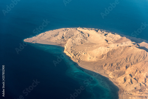 Top view of a part of the island among the blue sea