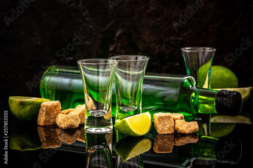 the concept of strong alcohol. Absinthe with a sugar cubes, lime slices. absinthe. space for text photo