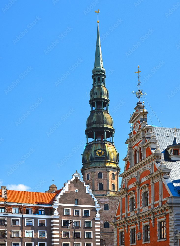 RIGA, LATVIA Ratslaukums square with St Peters church and House of Blackheads in old town of Riga in Latvia