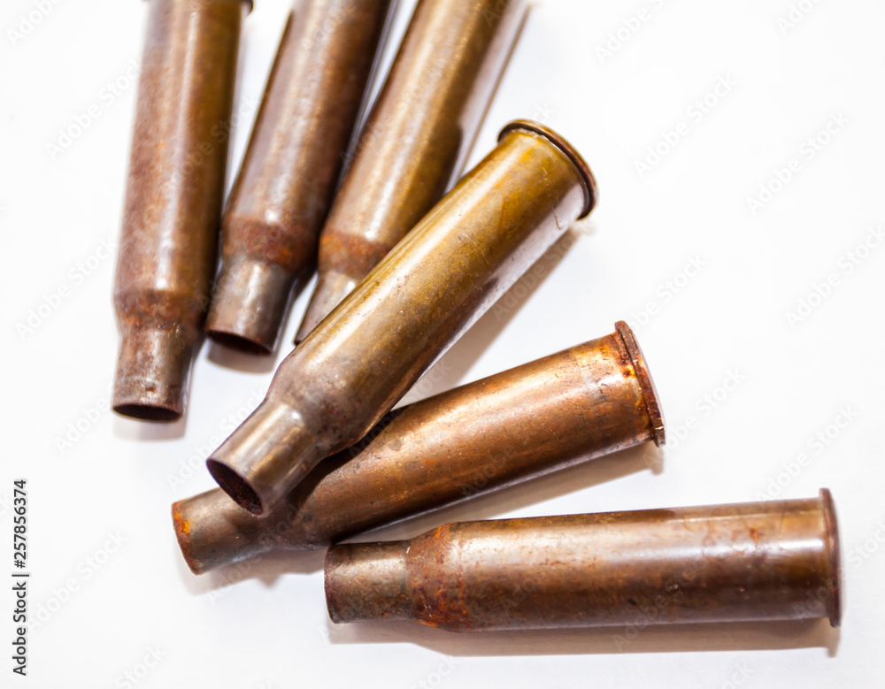 A pile bullet shells on a white background