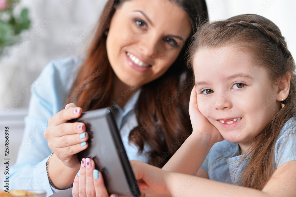 Close-up portrait of little girl with mother Close-up portrait of little girl with mother