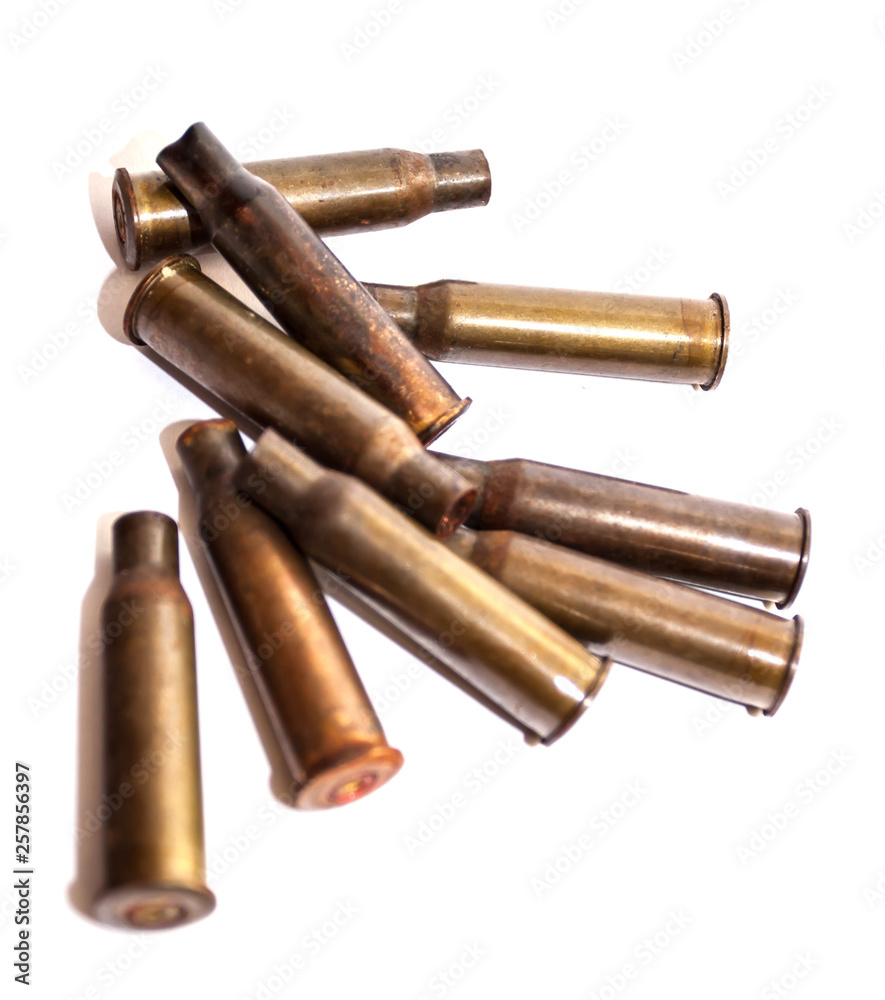 A pile bullet shells on a white background