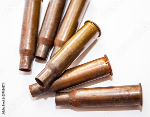 A pile bullet shells on a white background