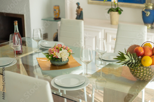 glass table setting with flower arrangement and fruit