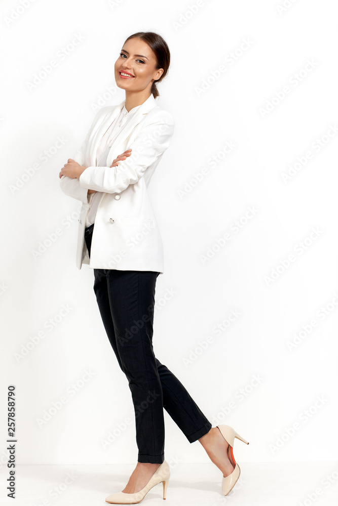 business woman standing with folded hands in pockets business woman standing with folded hands in pockets