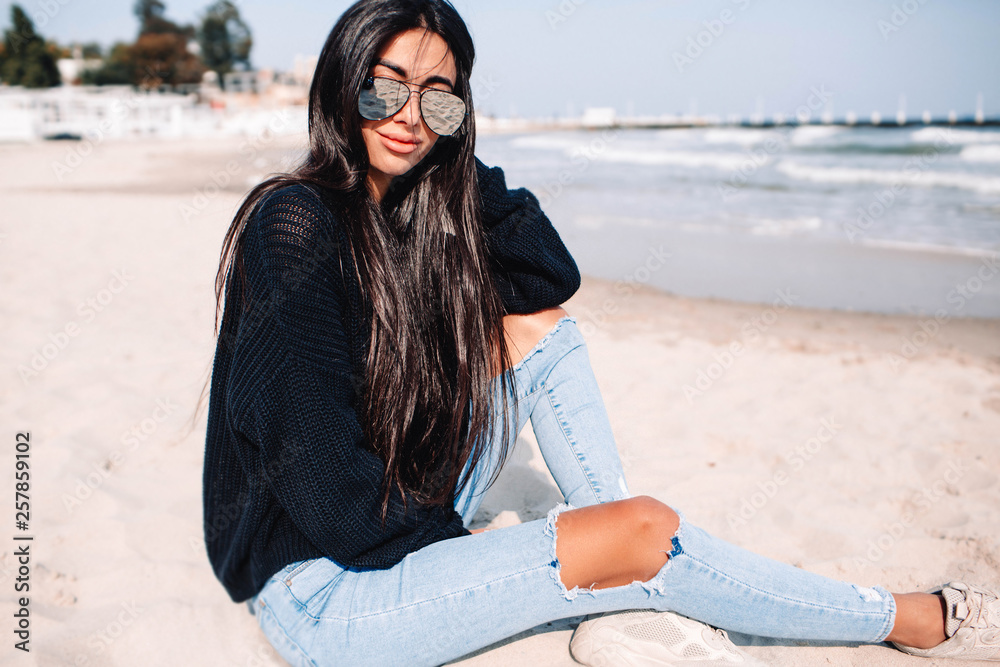 Close up portrait of beautiful young woman on the beach. Young caucasian female model on the sea shore.Great pleasure. Charming calm young woman is standing near sea with closed eyes.