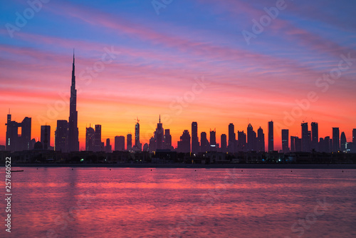 Mythical morning, sunrise or dusk in Dubai. Dawn over Burj Khalifa. Beautiful colored cloudy sky over Dubai downtown . Glow over buildings or skyscrapers © HLEB
