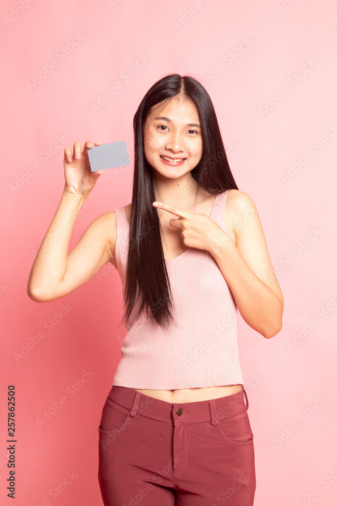 Young Asian woman point to a blank card. Young Asian woman point to a blank card.