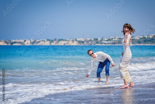 A man and a girl are on the beach.