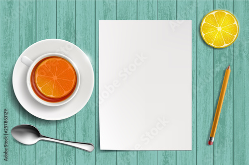 Blank white sheet of paper on a table. A cup of tea with lemon