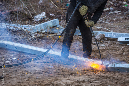 A worker cut steel beams using propane-oxygen torch..Oxy-fuel cutting.