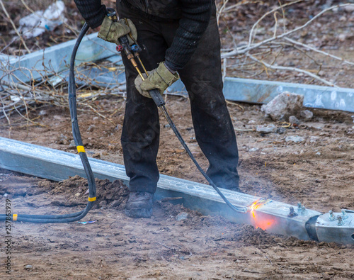 A worker cut steel beams using propane-oxygen torch..Oxy-fuel cutting.