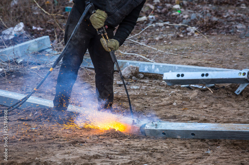 A worker cut steel beams using propane-oxygen torch..Oxy-fuel cutting. © Sodel Vladyslav