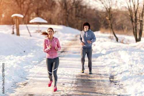 Fitness couple winter morning exercises. Winter fitness concept.