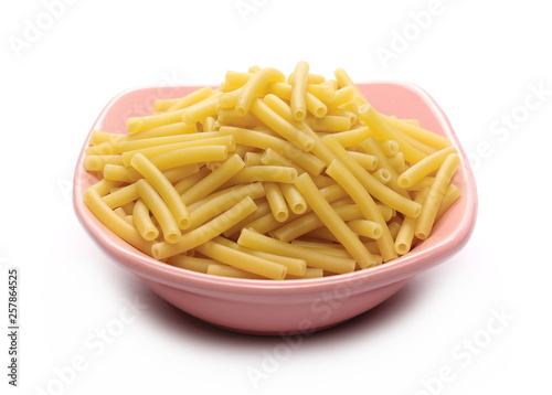 Macaroni, raw pasta in bowl isolated on white background