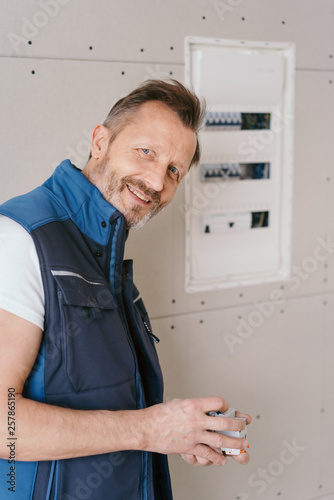 Friendly electrician working on a control panel