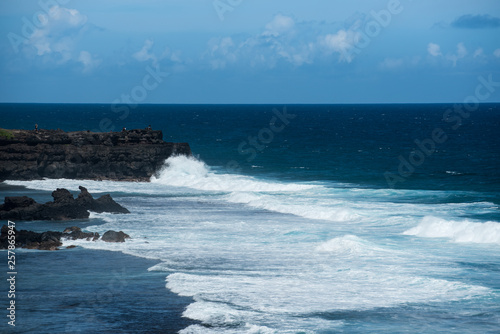 Waves crashing at rocky shore © ancamilushev