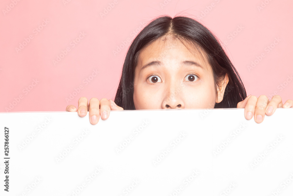 Close up of young Asian woman behind a blank sign. Close up of young Asian woman behind a blank sign.