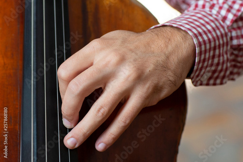 Cello playing cellist hand close up orchestra instruments