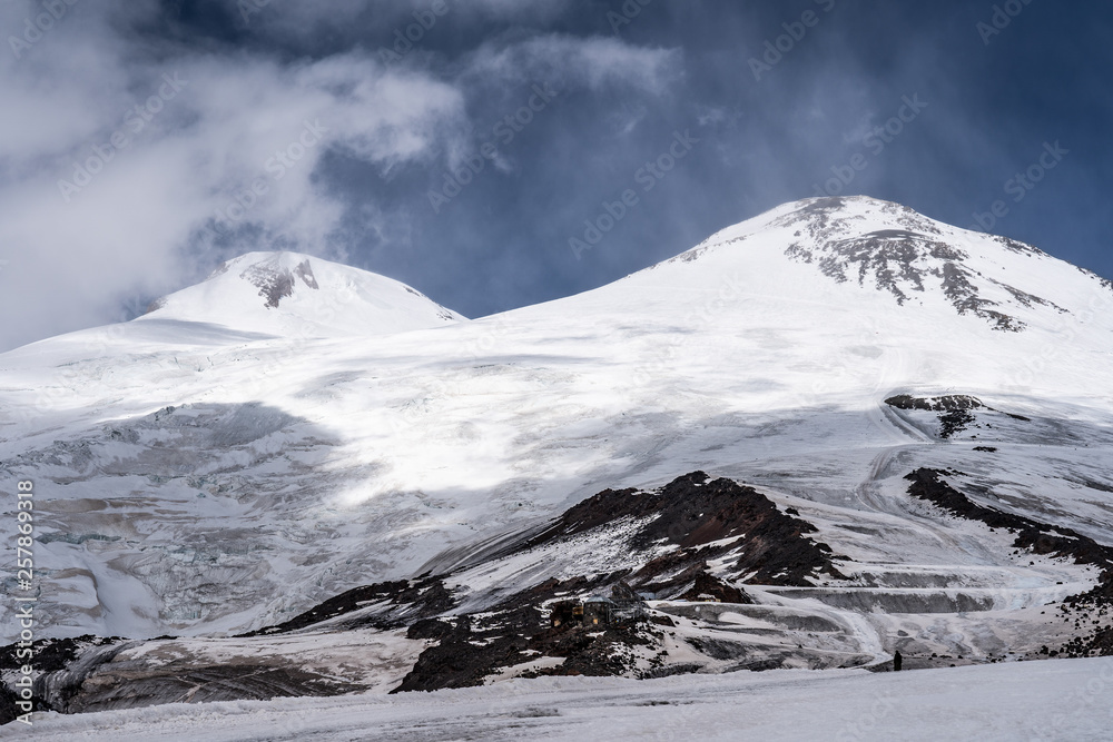 Amazing perspective of caucasian snow mountain or volcano Elbrus with blue sky background. Amazing perspective of caucasian snow mountain or volcano Elbrus with blue sky background.