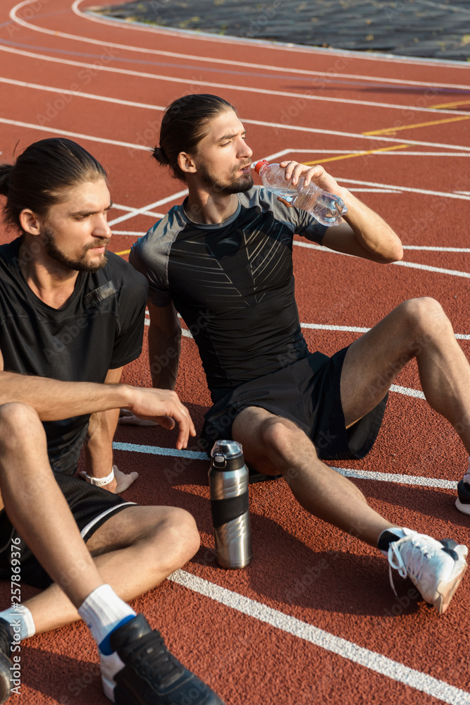 Two twin brothers resting after workout Two twin brothers resting after workout