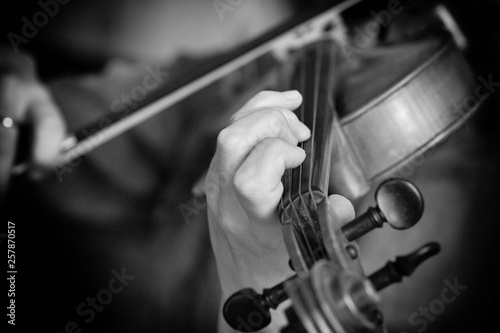 Violin player violinist classical music playing. Orchestra musical instruments Black and white image
