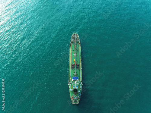 Aerial view Oil ship tanker on the green sea transportation oil from refinery. © Pawinee