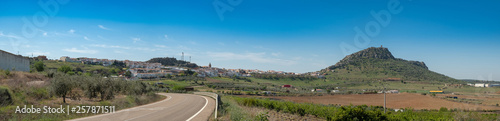 Panoramic view of the village of Alange with its castle on top of the mountain, next to the marsh of the same name, locality famous for its Roman baths and located Very close to the city of Merida.